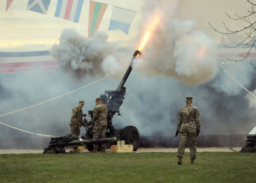 Soldiers firing off cannon