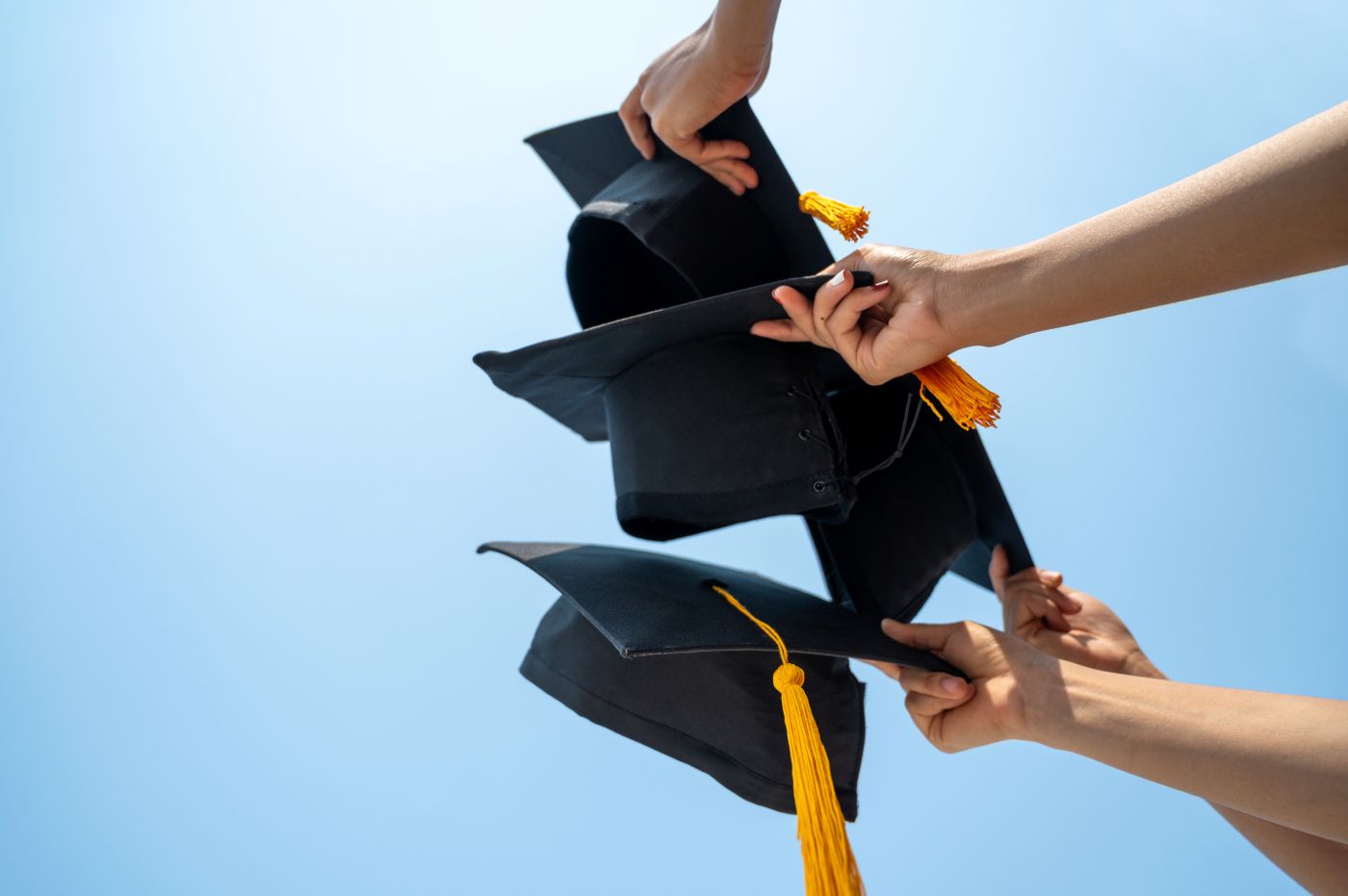A graduation ceremony of students throwing their graduation caps into the air
